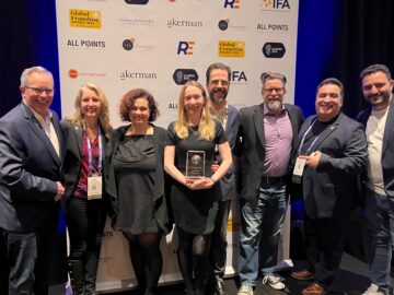 The Reshift Media team, along with the CFA’s Sherry McNeil and Lou Gervasi, accepting the best franchise marketing firm award at the 2023 Global Franchise Awards in Las Vegas.