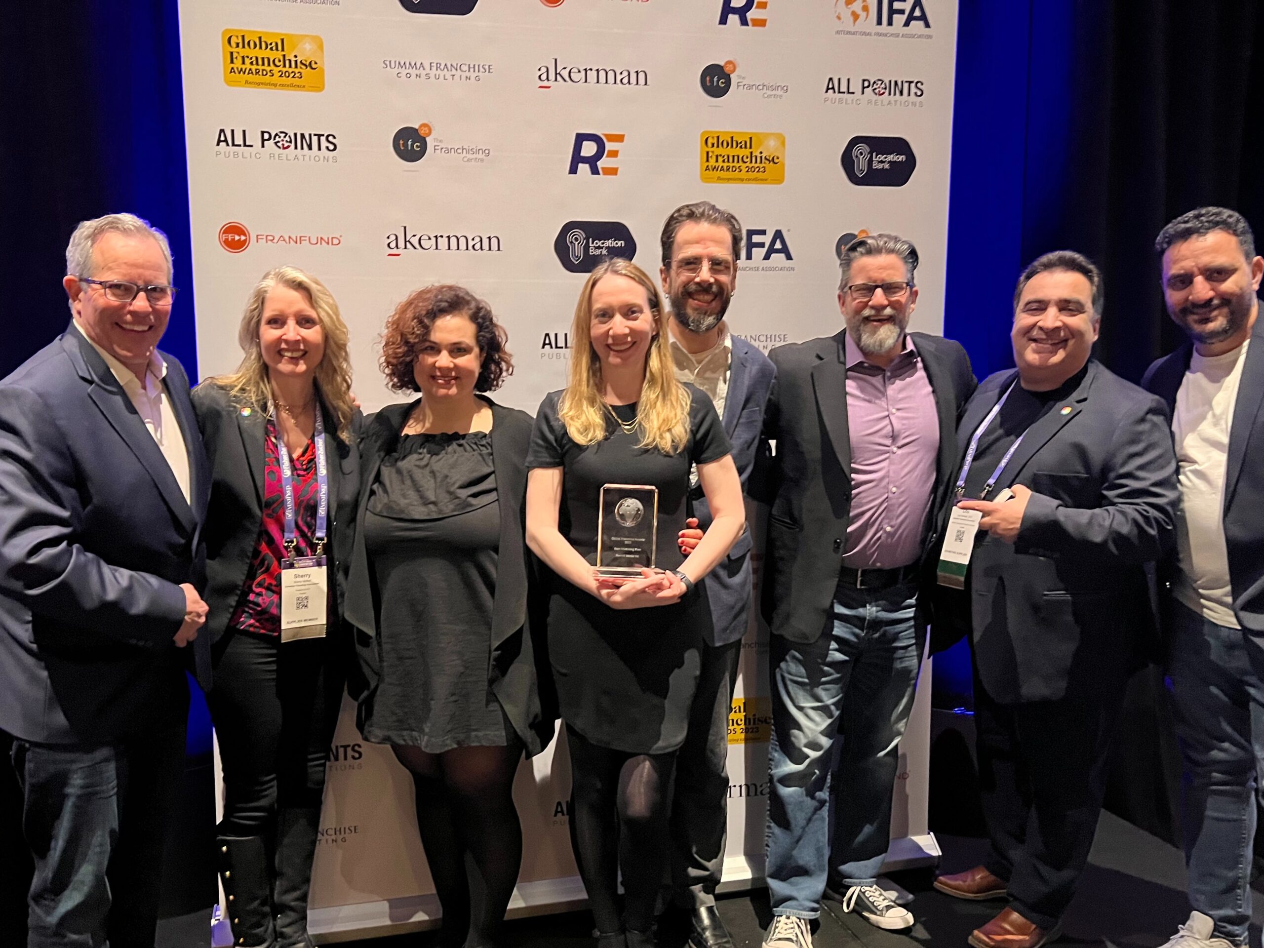 The Reshift Media team, along with the CFA’s Sherry McNeil and Lou Gervasi, accepting the best franchise marketing firm award at the 2023 Global Franchise Awards in Las Vegas.